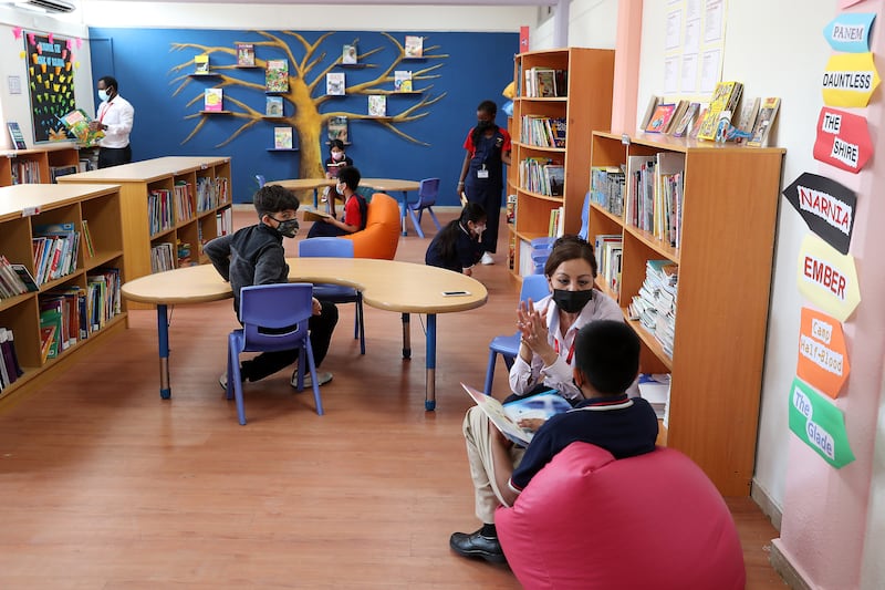 Year 4 students wearing face mask and sitting in the library of The Apple International Community School
