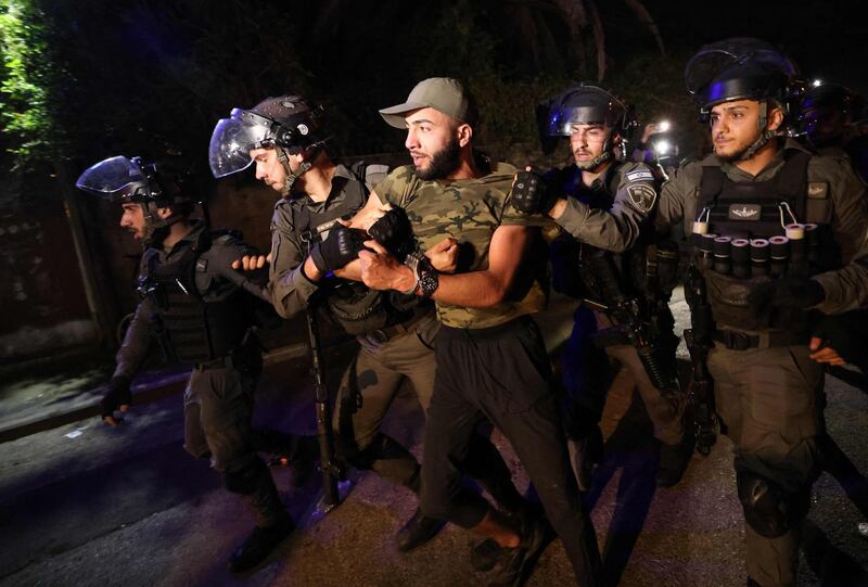 Riot policemen arrest a Palestinian protester in front of an Israeli settler's house during a demonstration against Israeli attempts to take control of homes in the Sheikh Jarrah neighbourhood of East Jerusalem, on May 5, 2021. AFP