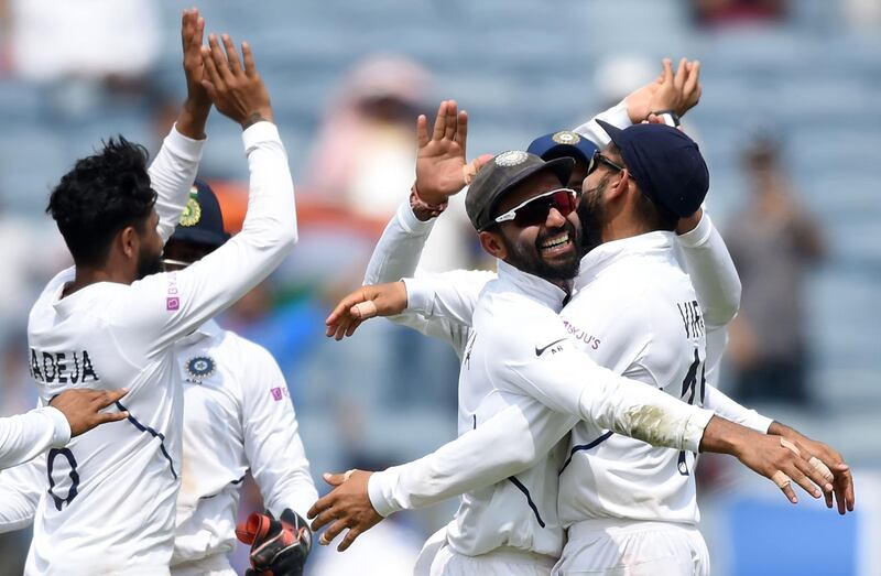 Ajinkya Rahane and Kohli celebrate the wicket of South Africa's batsman Temba Bavuma. AFP