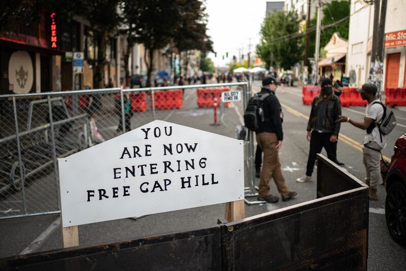 A sign is seen on a barrier at an entrance to the so-called "Capitol Hill Autonomous Zone" in Seattle, Washington. The zone includes the blocks surrounding the Seattle Police Departments East Precinct. Getty Images/AFP