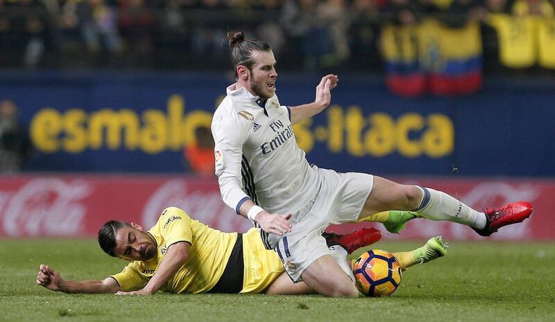 Real Madrid’s Welsh forward Gareth Bale, right, vies for the ball with Villarreal defender Jaume Costa. Miguel Angel Polo / EPA