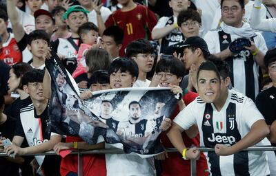 A South Korean soccer fans wears a mask of Cristiano Ronaldo of Juventus prior to a friendly match between Juventus and Team K League at the Seoul World Cup Stadium in Seoul, South Korea, Friday, July 26, 2019. (AP Photo/Ahn Young-joon)