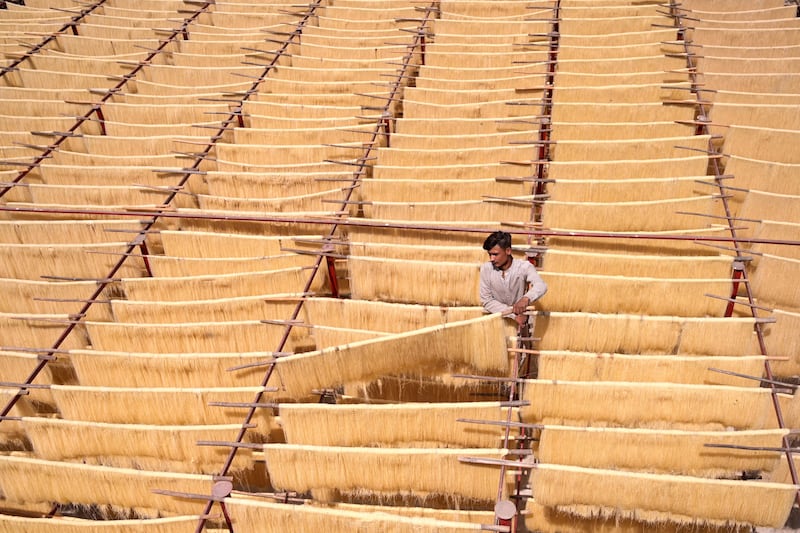 A man dries vermicelli, a popular ingredient used to make traditional Ramadan delicacies, in Hyderabad, Pakistan. AFP
