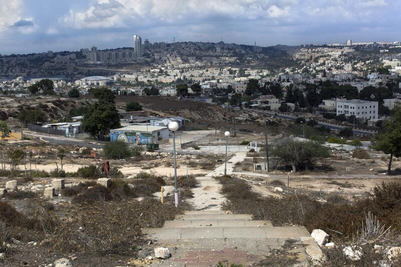  A staircase leading down a slope where several old caravans stand on the area of East Jerusalem called Givat Hamatos, overlooking Jerusalem.  Jim Hollander / EPA