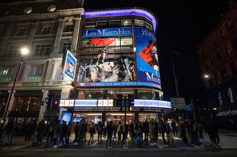 Staff from The Sondheim Theatre in London, inform theatregoers that all performances are cancelled because of the threat of COVID-19 virus, Monday March 16, 2020. Prime Minister Boris Johnson said Monday that â€œnow is the time for everyone to stop non-essential contact with others and to stop all unnecessary travel.â€ saying people should "avoid pubs, clubs, theatres and other such social venues." For most people, the coronavirus causes only mild or moderate symptoms, but for some it can cause a more severe illness, especially in older adults and people with pre-existing health problems. (Aaron Chown/PA via AP)