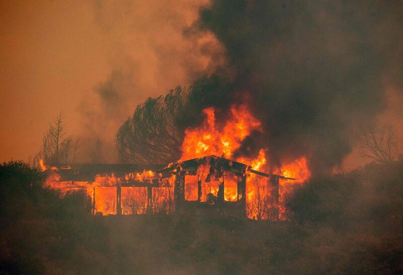 A house burns at the Mendocino Complex fire near Finley, California. AFP PHOTO / JOSH EDELSON