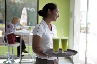 A waitress at a cafe in Abu Dhabi. A new survey reveals how UAE residents weight their tips for servers. Silvia Razgova / The National