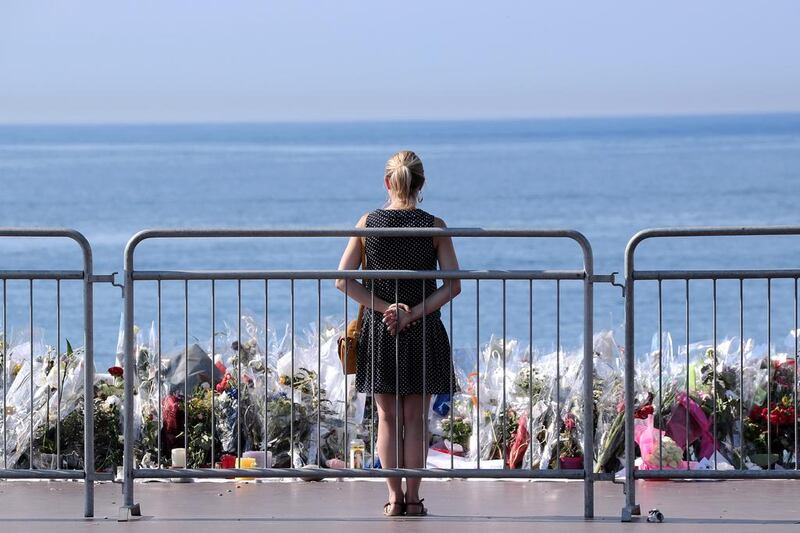 Flowers are lain at a makeshift memorial to the victims of the Bastille Day terrorist attack at the Promenade des Anglais, Nice, in July. The extremist attack killed 86 people. Valery Hache / AFP.