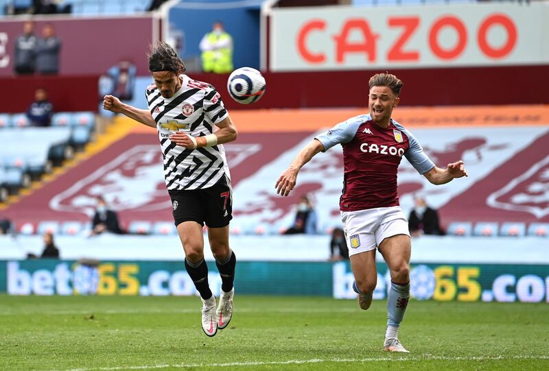 BIRMINGHAM, ENGLAND - MAY 09: Edinson Cavani of Manchester United scores their side's third goal whilst under pressure from Matthew Cash of Aston Villa during the Premier League match between Aston Villa and Manchester United at Villa Park on May 09, 2021 in Birmingham, England. Sporting stadiums around the UK remain under strict restr6ictions due to the Coronavirus Pandemic as Government social distancing laws prohibit fans inside venues resulting in games being played behind closed doors. (Photo by Shaun Botterill/Getty Images)