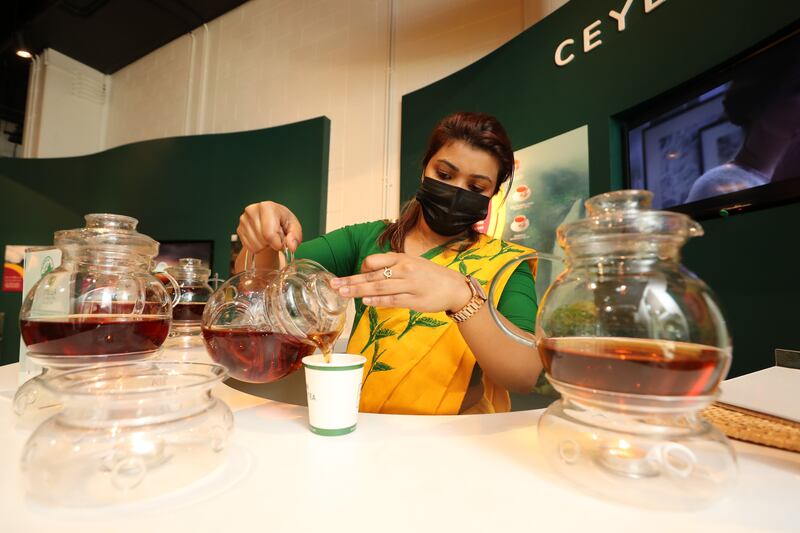 Madura Perera pours a cup of tea in the Sri Lanka pavilion.