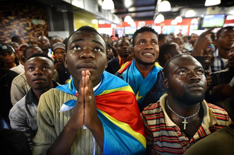 NOT FOR RESALE
JOHANNESBURG - 20130120 - Congo-supporter Lubina Shakesperare (links), vriend van Avsene Banza, kijkt in spanning naar de Afcon wedstrijd Congo-Ghana in Yeoville, Johannesburg.
Photo: Bram Lammers 
NOT FOR RESALE.
COPYRIGHT BRAM LAMMERS PHOTOGRAPHY
