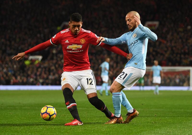 MANCHESTER, ENGLAND - DECEMBER 10:  Chris Smalling of Manchester United and David Silva of Manchester City in action during the Premier League match between Manchester United and Manchester City at Old Trafford on December 10, 2017 in Manchester, England.  (Photo by Michael Regan/Getty Images)