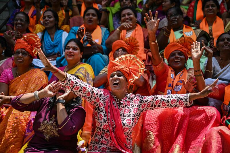 In Bengaluru, supporters of the Bharatiya Janata Party celebrate as election results appear on a big screen. AFP