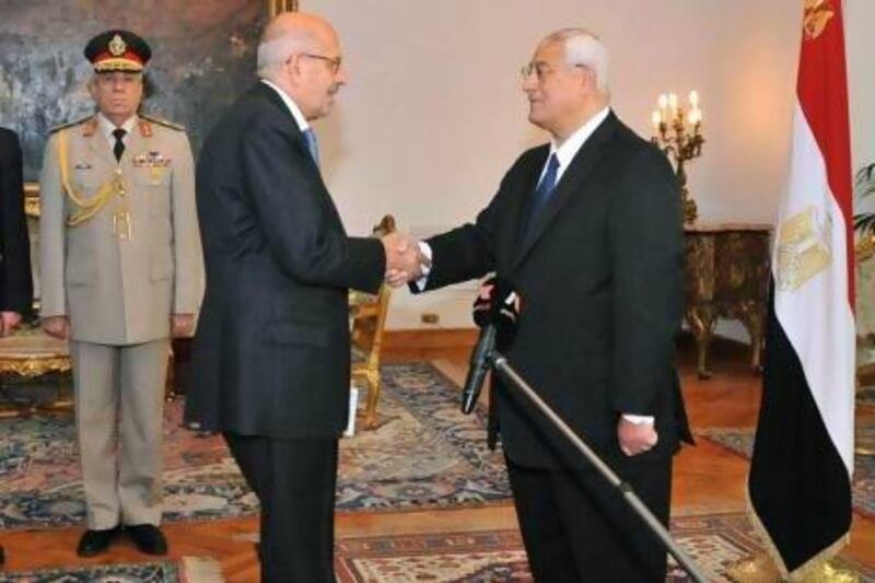 Pro-democracy leader Mohamed ElBaradei, a leader of the National Salvation Front, centre left, shakes hands with interim President Adly Mansour after being sworn in as vice president.
