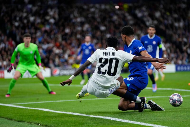 Real Madrid's Vinicius Junior tries to pass the ball as Chelsea's Wesley Fofana defends in the penalty box. AP 