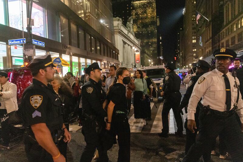 A New York Police Department officer leads away an arrested protester outside Grand Central Terminal during a rally calling for a ceasefire between Israel and Hamas. AP Photo
