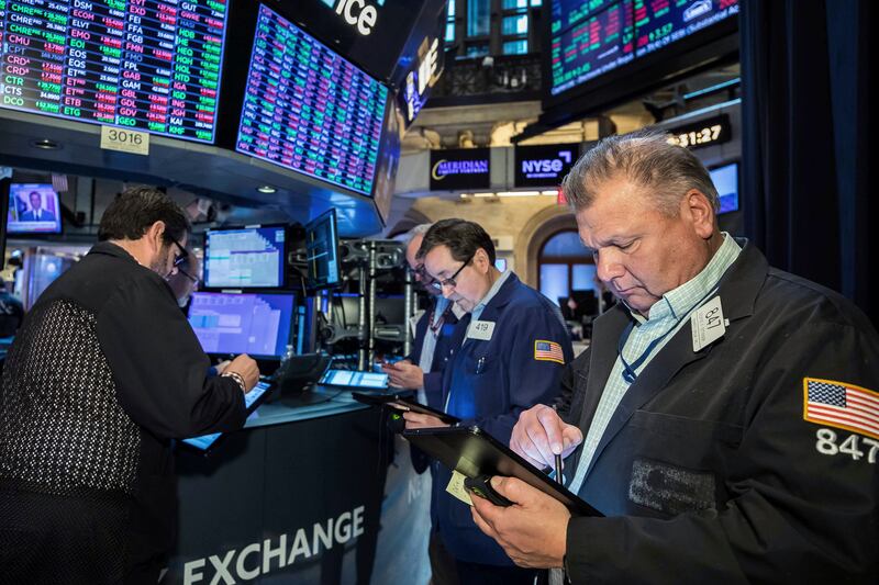 Traders at the New York Stock Exchange. Global stock markets are expected to remain volatile amid central bank rate decisions and inflationary data. AP