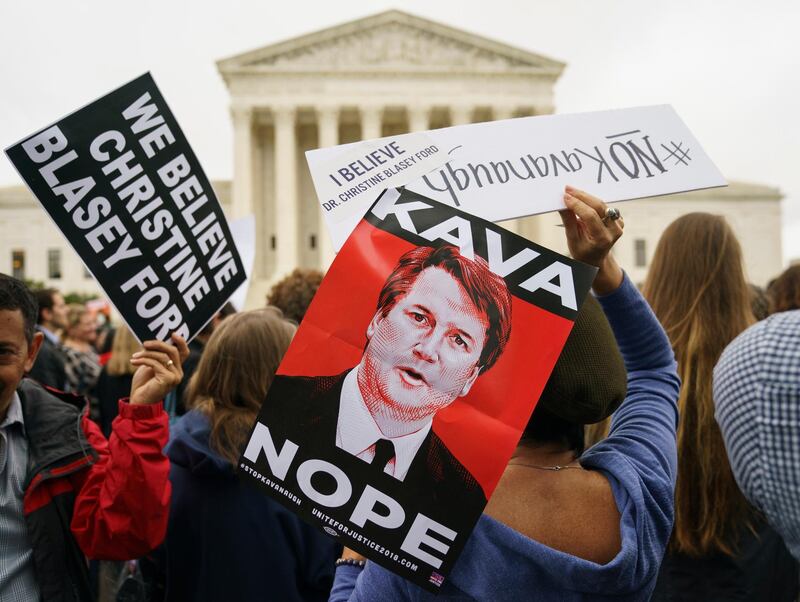 Protesters gather in front of the Supreme Court holding signs with the image of Judge Brett Kavanaugh that read "Kava Nope" and "We Believe Christine Blasey Ford" on Capitol Hill in Washington, Monday, Sept. 24, 2018. A second allegation of sexual misconduct has emerged against Judge Brett Kavanaugh, a development that has further imperiled his nomination to the Supreme Court, forced the White House and Senate Republicans onto the defensive and fueled calls from Democrats to postpone further action on his confirmation. President Donald Trump is so far standing by his nominee. (AP Photo/Carolyn Kaster)