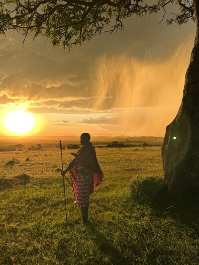 A Masai warrior stands guard under an acacia tree. David Tusing / The National
