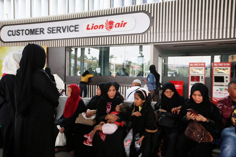 Passengers await for their flight in front of a Lion Air office at Soekarno Hatta International airport. Reuters