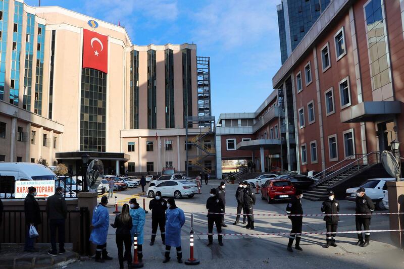 Police and medics gather outside the privately-run Sanko University Hospital in Gaziantep, southeastern Turkey, Saturday, De. 19, 2020. A fire broke out Saturday at an intensive care unit treating COVID-19 patients in southern Turkey after an oxygen cylinder exploded, killing several people, state-run media reported. (Kadir Gunes/DHA via AP)