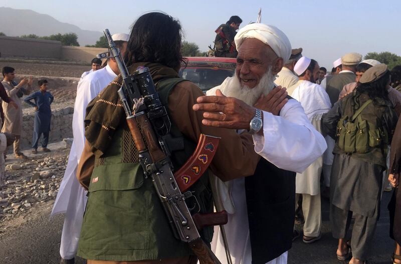 Taliban fighters gather with the residences in Surkhroad district of Nangarhar province, east of Kabul, Afghanistan, Saturday, June 16, 2018. A suicide bomber blew himself up in eastern Afghanistan on Saturday as mostly Taliban fighters gathered to celebrate a three-day cease fire marking the Islamic holiday of Eid al-Fitr, killing 21 people and wounding another 41, said the Nangarhar provincial Police Chief Ghulam Sanayee Stanikzai. Most of the dead and wounded were believed to be Taliban, he said. (AP Photo/Rahmat Gal)