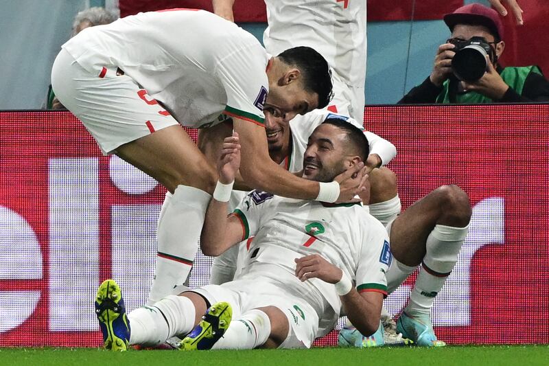 Ziyech is congratulated by teammates. AFP