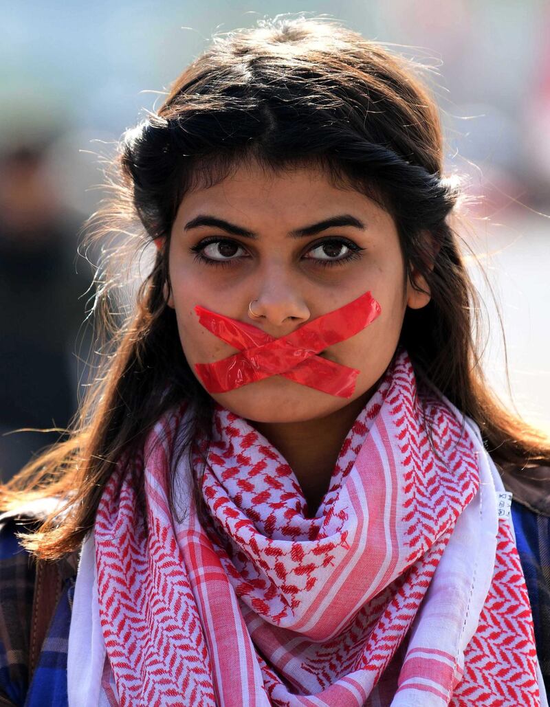 An Iraqi university student with mouth taped attends a protest in central Baghdad, Iraq.  EPA