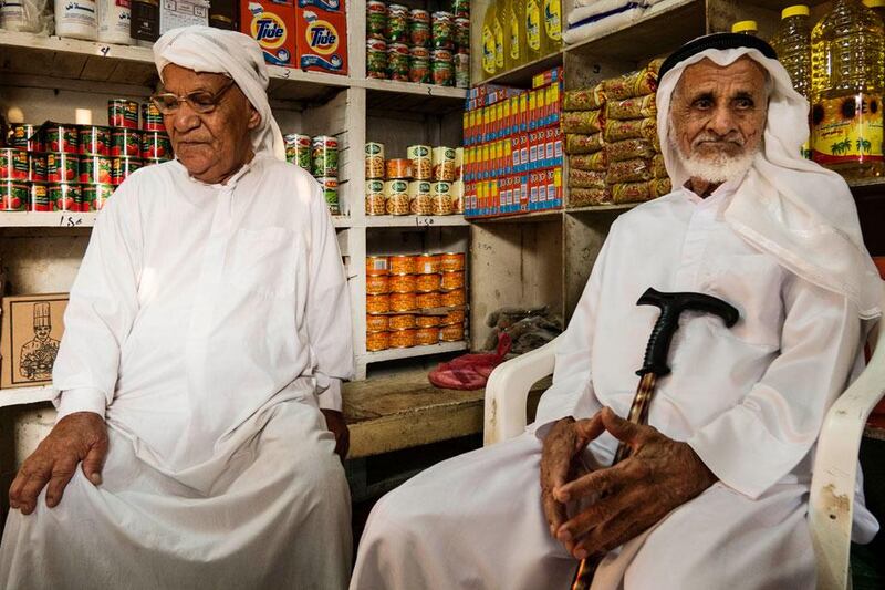 Ali Mohammed and Ali Obaid Humeid, both in their 60s, sit in their  
friend Mohammed Khasan's shop.