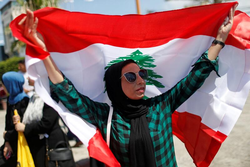 A Palestinian woman holds a Lebanese flag to show solidarity with the Lebanese people following Tuesday's blast in Beirut's port area, in Gaza City August 6, 2020. REUTERS/Mohammed Salem