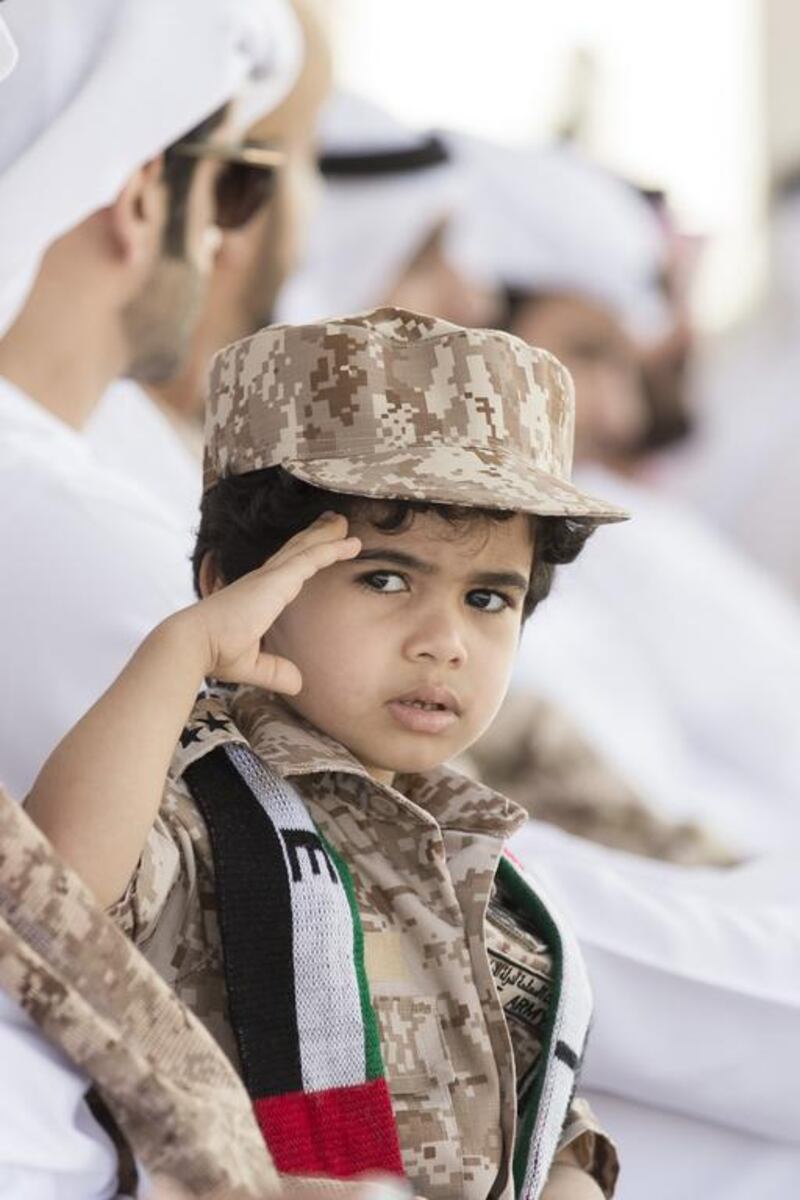 A young guest at the ceremony. Philip Cheung for Crown Prince Court - Abu Dhabi