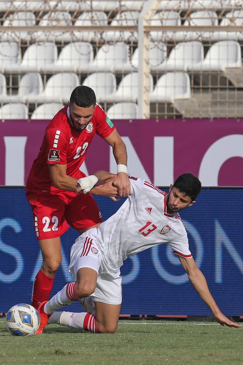 Lebanon's Bassel Jradi and Ahmed Barman of the UAE battle for ball. AFP