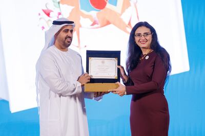 Egyptian author Reem Bassiouney received her Sheikh Zayed Book Award from Sheikh Theyab bin Mohamed. Photo: Zoran Milrcetic / Abu Dhabi Arabic Language Centre