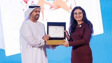 Egyptian author Reem Bassiouney receives her Sheikh Zayed Book Award from Sheikh Theyab bin Mohamed. Photo: Zoran Milrcetic / Abu Dhabi Arabic Language Centre
