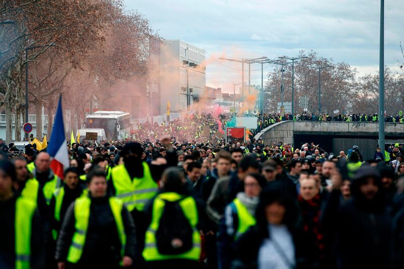 Yellow Vest (Gilets Jaunes) protesters rally in Lyon on February 9, 2019 as they take to the streets for the 13th consecutive Saturday. The "Yellow Vests" (Gilets Jaunes) movement in France originally started as a protest about planned fuel hikes but has morphed into a mass protest against the French President's policies and top-down style of governing. / AFP / ALEX MARTIN
