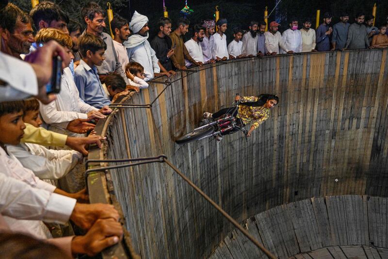 Fatima Noor performing in a 'Wall of Death' stunt during an annual carnival at a Sufi shrine in Shah Jiwana, in Pakistan's Punjab province. AFP