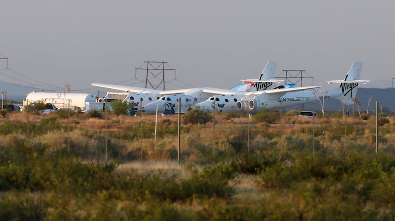 Virgin Galactic's passenger rocket plane 'VSS Unity', borne by a twin-fuselage carrier jet called 'VMS Eve', before its launch in New Mexico.