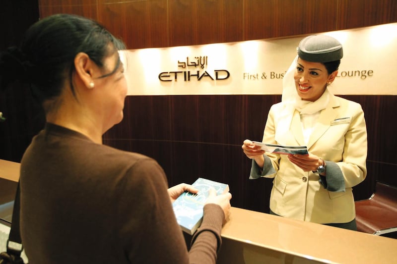ABU DHABI. 31st March. 2009. ETIHAD BUSINESS CLASS. Fathia Brik welcomes a passenger at the new Terminal 3 Etihad Business lounge at  Abu Dhabi International airport.  Stephen Lock  /  The National. FOR ARTS & LIFE *** Local Caption ***  SL-etihad-006.jpg