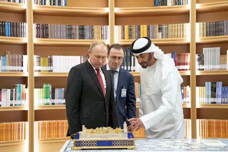 ABU DHABI, UNITED ARAB EMIRATES - October 15, 2019: HH Sheikh Mohamed bin Zayed Al Nahyan, Crown Prince of Abu Dhabi and Deputy Supreme Commander of the UAE Armed Forces (R) and HE Vladimir Putin Vladimirovich, President of Russia (L), exchange gifts during a state visit at Qasr Al Watan. ( Mohamed Al Hammadi / Ministry of Presidential Affairs )---