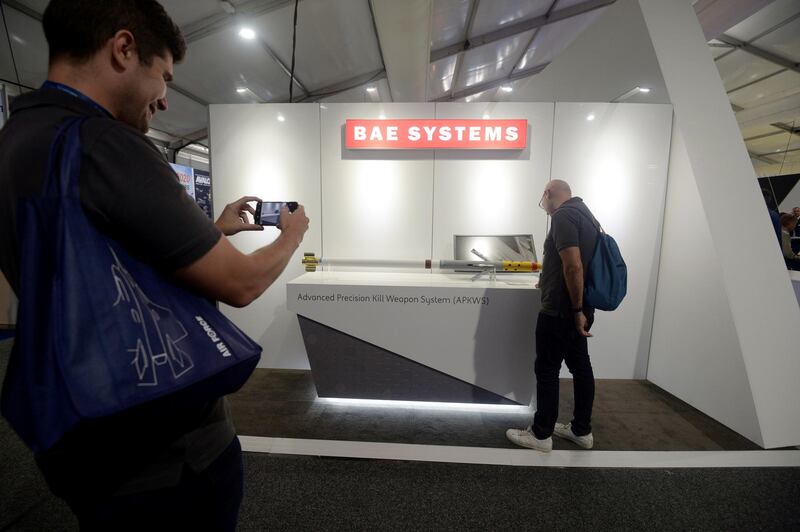 An attendees poses for a photograph with a model of a BAE Systems Plc Advanced Precision Kill Weapon System (APKWS) rocket on display at the company's booth during the Australian International Aerospace & Defence Exposition held at Avalon Airport in Geelong, Australia, on Tuesday, Feb. 28, 2019. The airshow runs through March 3. Photographer: Carla Gottgens/Bloomberg