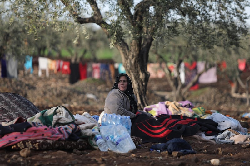 A displaced Syrian woman rests under a tree in a field on the outskirts of the rebel-held town of Jindayris. AFP