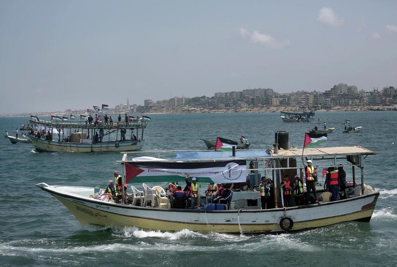 Two Palestinian fishing boats sail carrying 20 people including medical patients and students unable to leave through overland crossings, in Gaza City, Tuesday, May 29, 2018. Palestinian activists have set sail in defiance of years of an Israeli and Egyptian naval blockade on the Gaza Strip. (AP Photo/Khalil Hamra)