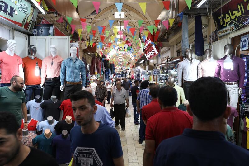 People go shopping ahead of the Eid al-Fitr holidays, in the West Bank city of Nablus. EPA