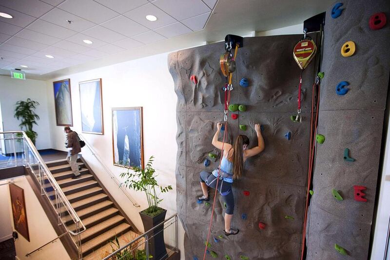 An employee uses the climbing wall during the grand opening of Google Kirkland in 2009. Stephen Brashear / Getty Images / AFP