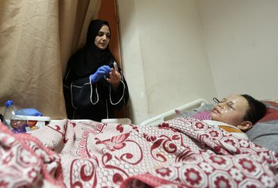 Hanan's mother Walaa looks at her in her bed at Al Aqsa Martyrs Hospital. Reuters