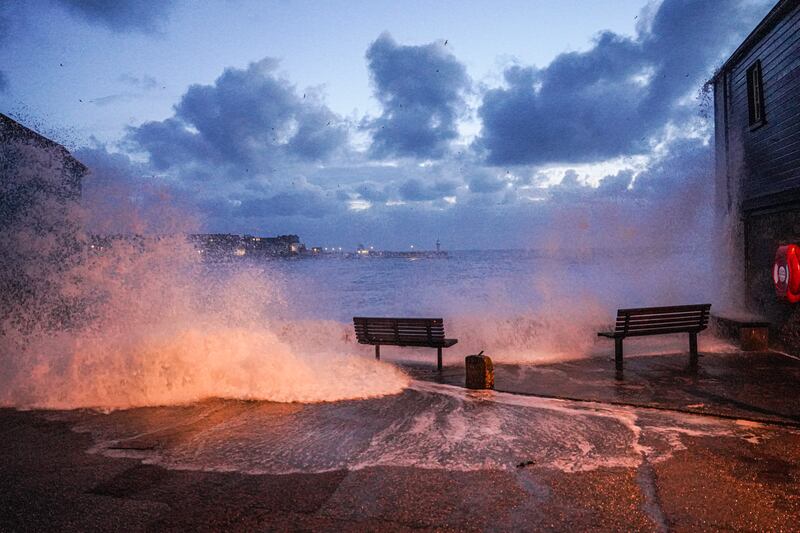 Waves crash over the harbour wall in the early morning in St Ives, Cornwall, England, during Storm Kathleen. Getty Images