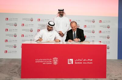 Sheikh Khalid bin Mohamed bin Zayed oversees Mohamed Al Mubarak and Roger Brown of Berklee signing the deal. Courtesy: DCT Abu Dhabi