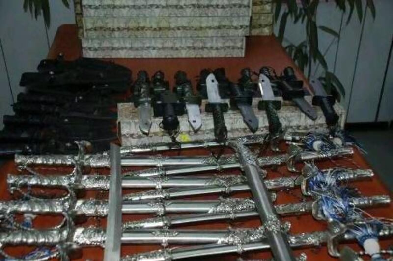 Twenty-one knives and 14 swords were seized from the shop in Al Dhaid.