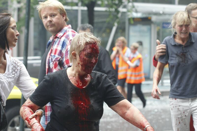 Injured people are escorted from the area of an explosion in central Oslo Friday, July 22, 2011. Terrorism ravaged long-peaceful Norway on Friday when a bomb ripped open buildings including the prime minister's office and a man dressed as a police officer opened fire at a nearby island youth camp. (AP Photo/Scanpix, Berit Roald)  NORWAY OUT *** Local Caption ***  Norway Explosion .JPEG-042b9.jpg