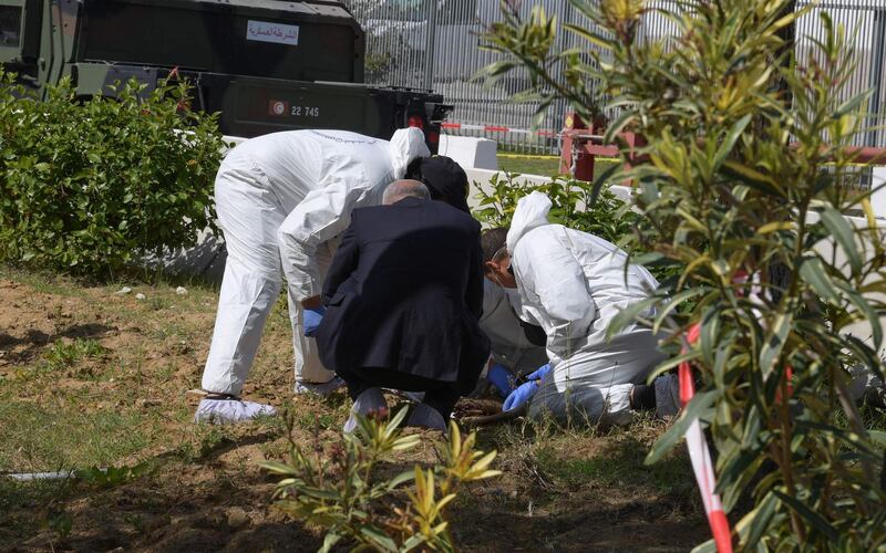 Forensic experts investigate at the scene of an explosion near the US embassy in Tunis. AFP